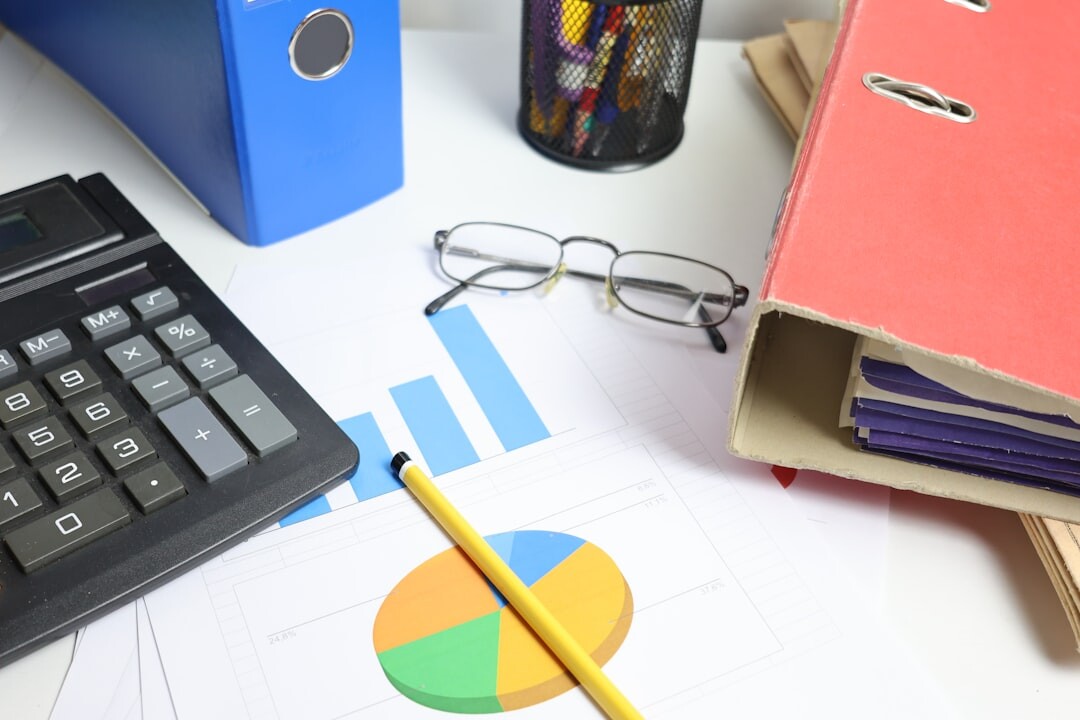 Stack of organized legal folders with a magnifying glass on a desk